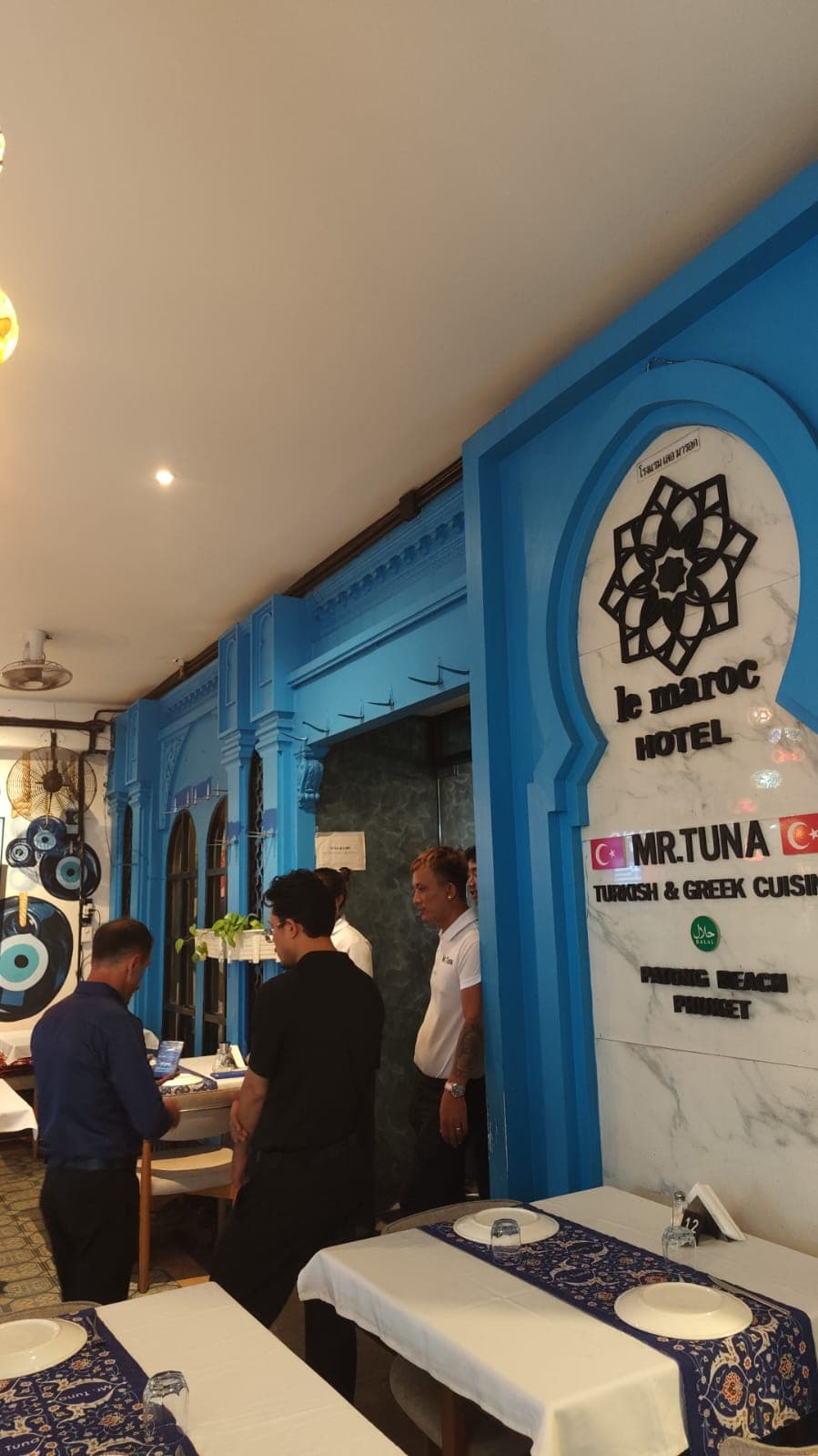 Blue walls and Mr. TUNA signage at the restaurant entrance